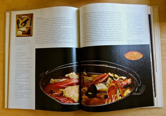 Open magazine featuring a recipe with a large pot of stew and ingredients on a wooden table.