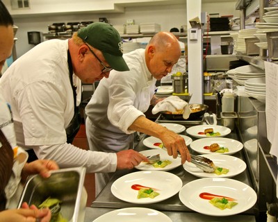 Chefs preparing gourmet dishes with fresh ingredients at a Lodi Winegrape Commission event.