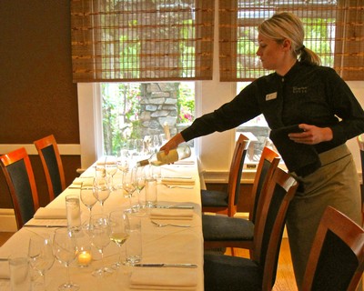 Wine tasting setup with glasses and a server at Lodi Winegrape Commission event.