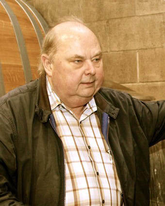Man at Lodi Winegrape Commission event, wearing a plaid shirt and black jacket.