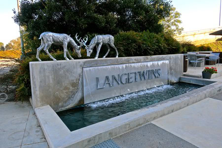 Lodi Winegrape Commission sign with water fountain and decorative metal deer sculptures.
