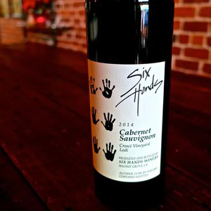 Bottle of 2014 Cabernet Sauvignon from Lodi Winegrape Commission with handprint design label.