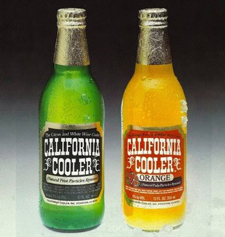Two California Cooler bottles, one green and one orange, with condensation, on a dark background.