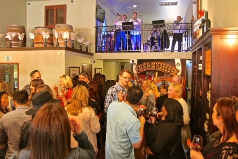 Crowd of people enjoying a wine tasting event at Lodi Winegrape Commission venue.