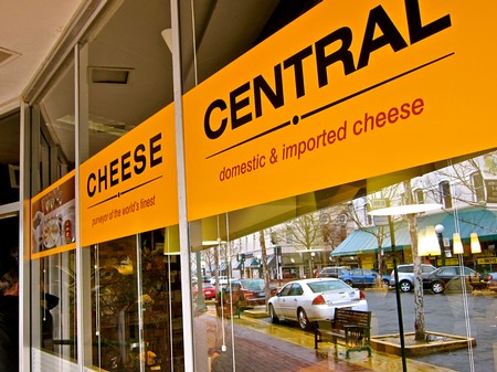 Sign for cheese at Lodi Winegrape Commission with outdoor view of parking lot and street.