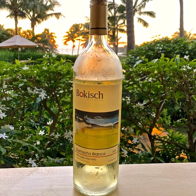 Bokisch Samocha Blanca white wine bottle from Lodi Winegrape Commission, with vineyard background at sunset.