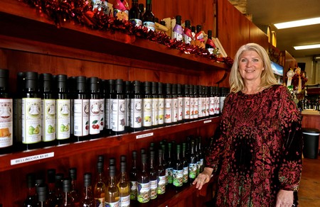 Woman standing next to wine and grape juice bottles at Lodi Winegrape Commission.