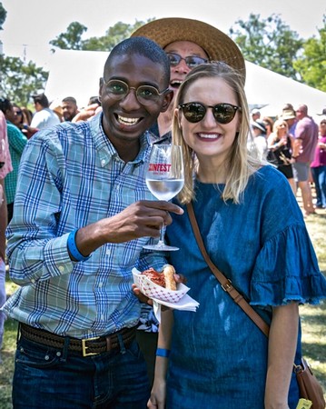 Smiling couple enjoying wine at Lodi Winegrape Commission outdoor event.