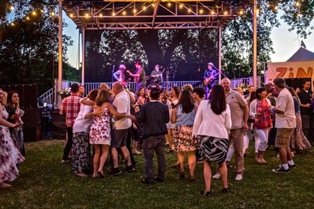 People enjoying live music and socializing at an outdoor event organized by Lodi Winegrape Commission.