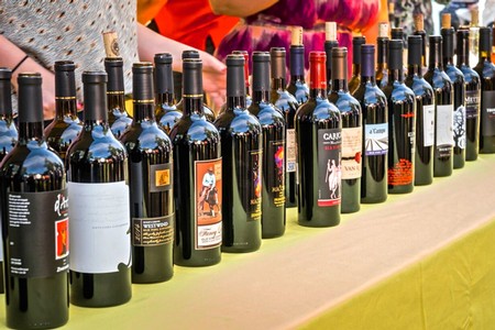 Collection of wine bottles displayed at the Lodi Winegrape Commission event for wine tasting and promotion.