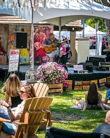 Live music performance at a Lodi wine event with audience enjoying the outdoor setting.