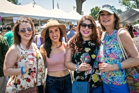 Four women enjoying wine tasting at the Lodi Winegrape Commission outdoor event.