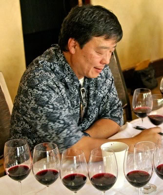 Man tasting and evaluating red wine at Lodi Winegrape Commission event.