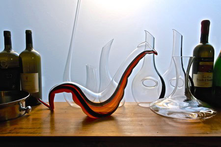 Colorful glass sculptures and wine bottles on wooden surface for Lodi Winegrape Commission.