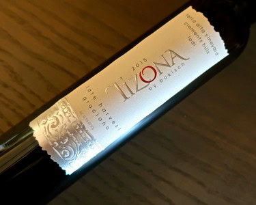 Close-up of a 2015 Izona wine bottle label from Lodi Winegrape Commission, showcasing elegant design and vintage details.