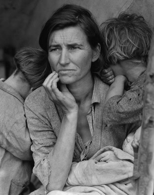 Black and white photo of a woman with two children, showing concern and contemplation.