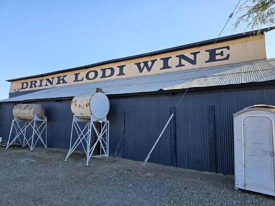 Lodi Winegrape Commission building with tanks and signage for wine tasting and production.