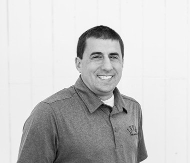 Smiling man in a polo shirt standing against a white background, representing Lodi Winegrape Commission.