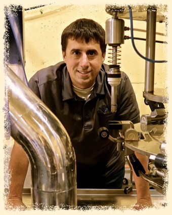 Researcher working in a laboratory with scientific equipment for winegrape analysis in Lodi, California.