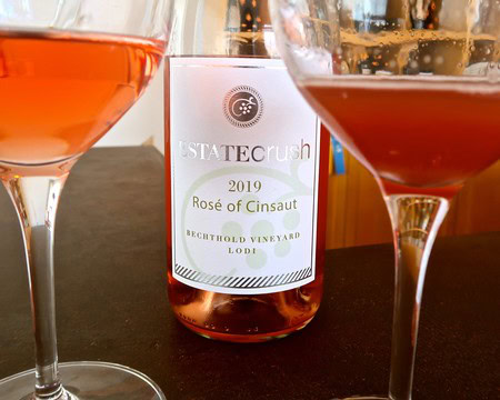 Lodi Rosé of Cinsaut wine bottle with two glasses of rosé wine.