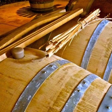 Wooden wine barrels with wine tools on top, representing Lodi Winegrape Commission.