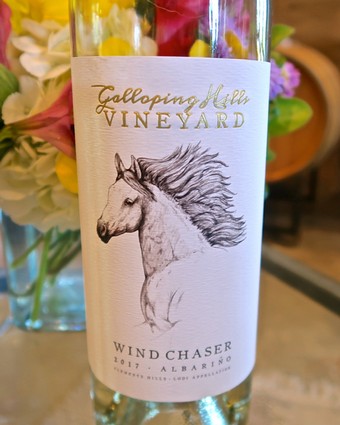 Bottle of Wind Chaser 2017 Albarino wine from Lodi Winegrape Commission with a horse illustration on label.