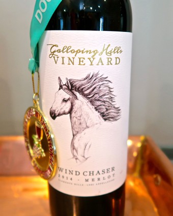 Bottle of Wind Chaser Merlot from Galloping Hill Vineyard with medal and teal ribbon.