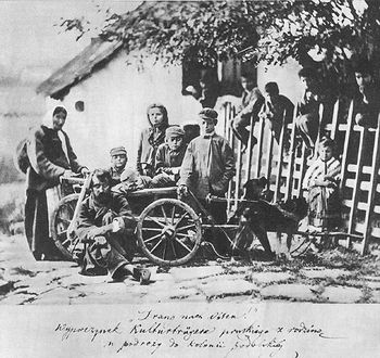 Vintage photo of early Lodi winegrowers with tools and a horse-drawn cart.