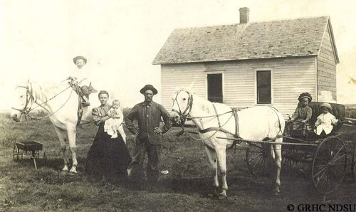 Vintage photo of early Lodi winegrowers with horses and a barn, showcasing historic viticulture practices.