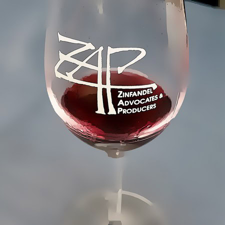 Glass of red wine with Lodi Winegrape Commission logo and text in white and red.