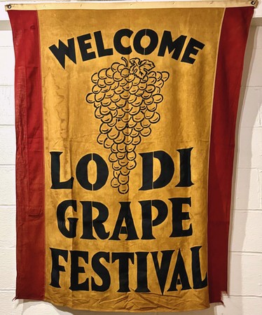 Welcome banner for Lodi Grape Festival with grape cluster illustration and bold text.