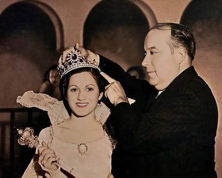 A woman being crowned at a Lodi Winegrape Commission event, with a man placing a crown on her head.