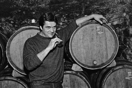 Man tasting wine from barrel at Lodi Winegrape Commission event, showcasing local wine production.
