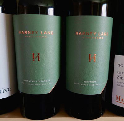 Harney Lane Zinfandel wine bottle with green label on store shelf.