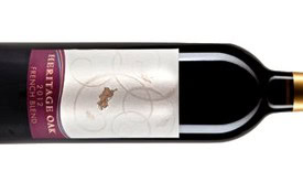 A bottle of wine from the Lodi Winegrape Commission featuring a white label with a grapevine illustration.
