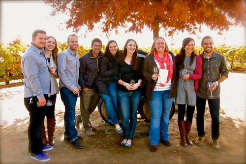Group of people at Lodi Winegrape Commission event with vineyards in the background.