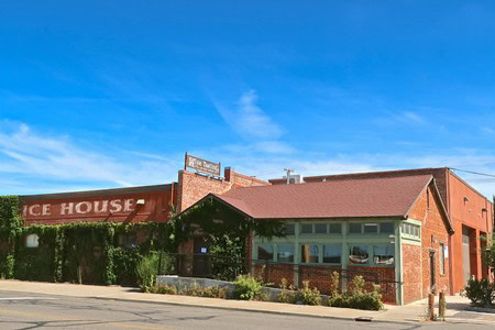 Lodi Winegrape Commission building in downtown Lodi, California, with a clear blue sky and brick architecture.