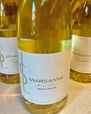 Close-up of a Lodi wine bottle from Marsanne Vineyards with a white label and gold accents.