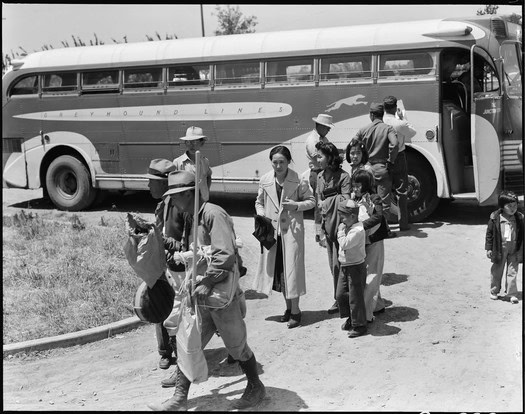 Group of people boarding a vintage bus for a wine tour at Lodi Winegrape Commission.