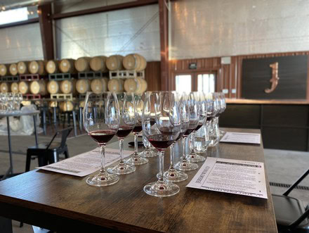 Wine glasses with red wine on a table at a wine tasting event by Lodi Winegrape Commission.