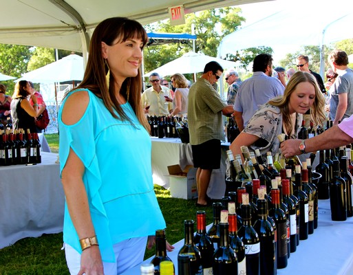 People enjoying wine tasting at Lodi Winegrape Commission outdoor event in California.