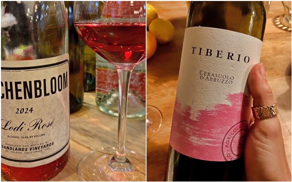 Close-up of wine bottles and glass of red wine on a wooden table, showcasing Lodi wine varieties.