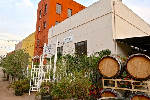 Lodi Winegrape Commission building with wine barrels and grapevines in Lodi, California.