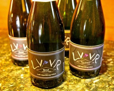 Four bottles of Lodi sparkling wine on a granite countertop, showcasing the Lodi Winegrape Commission branding.