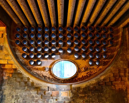 Close-up of a large industrial pipe system used in wine production at Lodi Winegrape Commission.