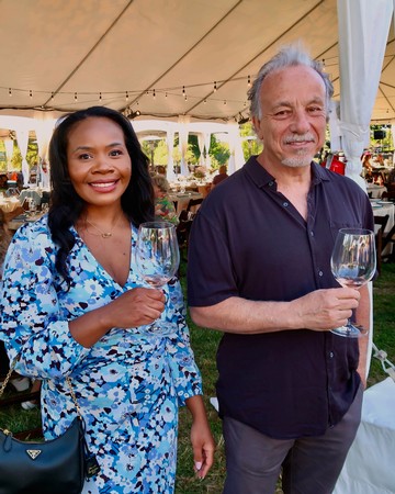 Two people enjoying wine at a Lodi Winegrape Commission event outdoors.