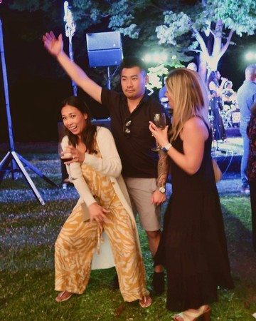 Group of friends enjoying an outdoor evening event with music and lights, celebrating Lodi wine culture.