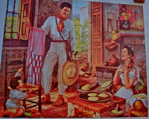 Colorful painting of a family in a rustic kitchen, with a man holding a hat and a woman sitting by a stove with bread.