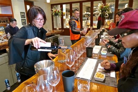 Wine tasting at Lodi Winegrape Commission with attendees sampling wines at a bar.