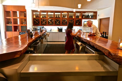 Interior of a wine tasting bar with a bartender serving a customer in Lodi, California.